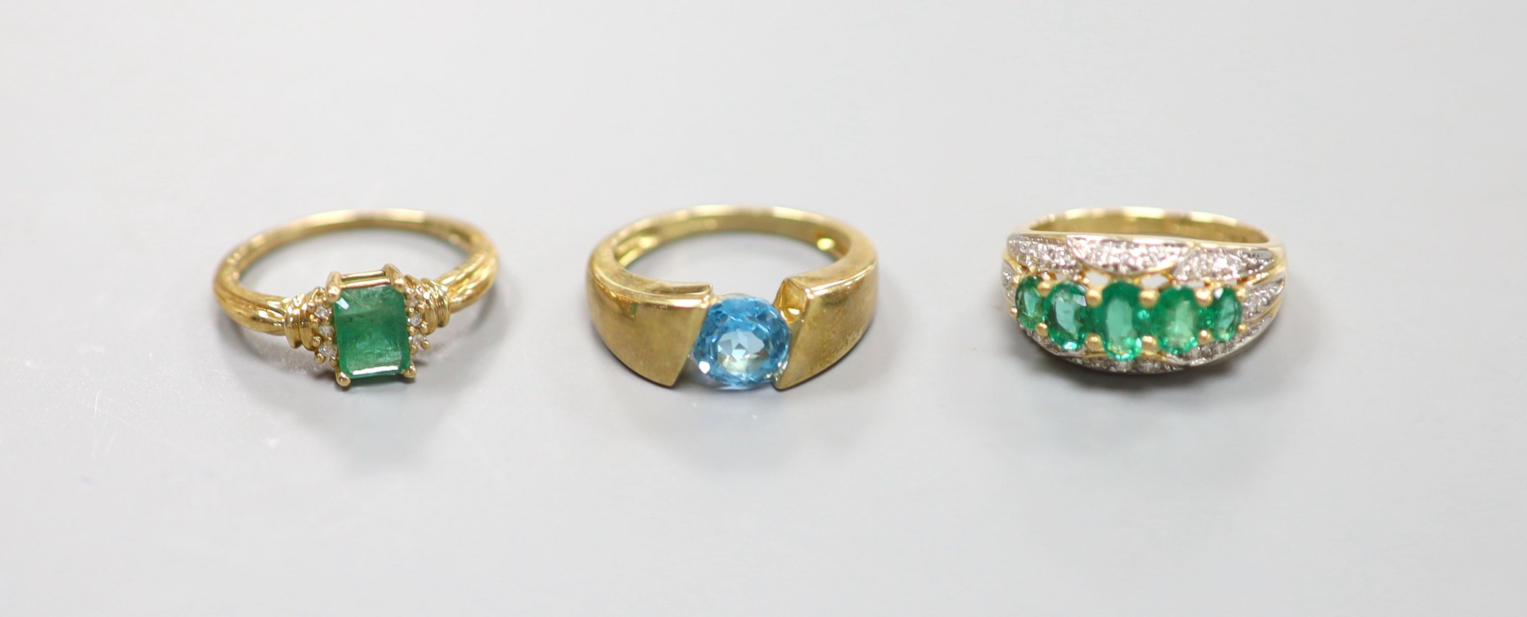 Two 9ct gold emerald-set rings and another 9k gem-set ring